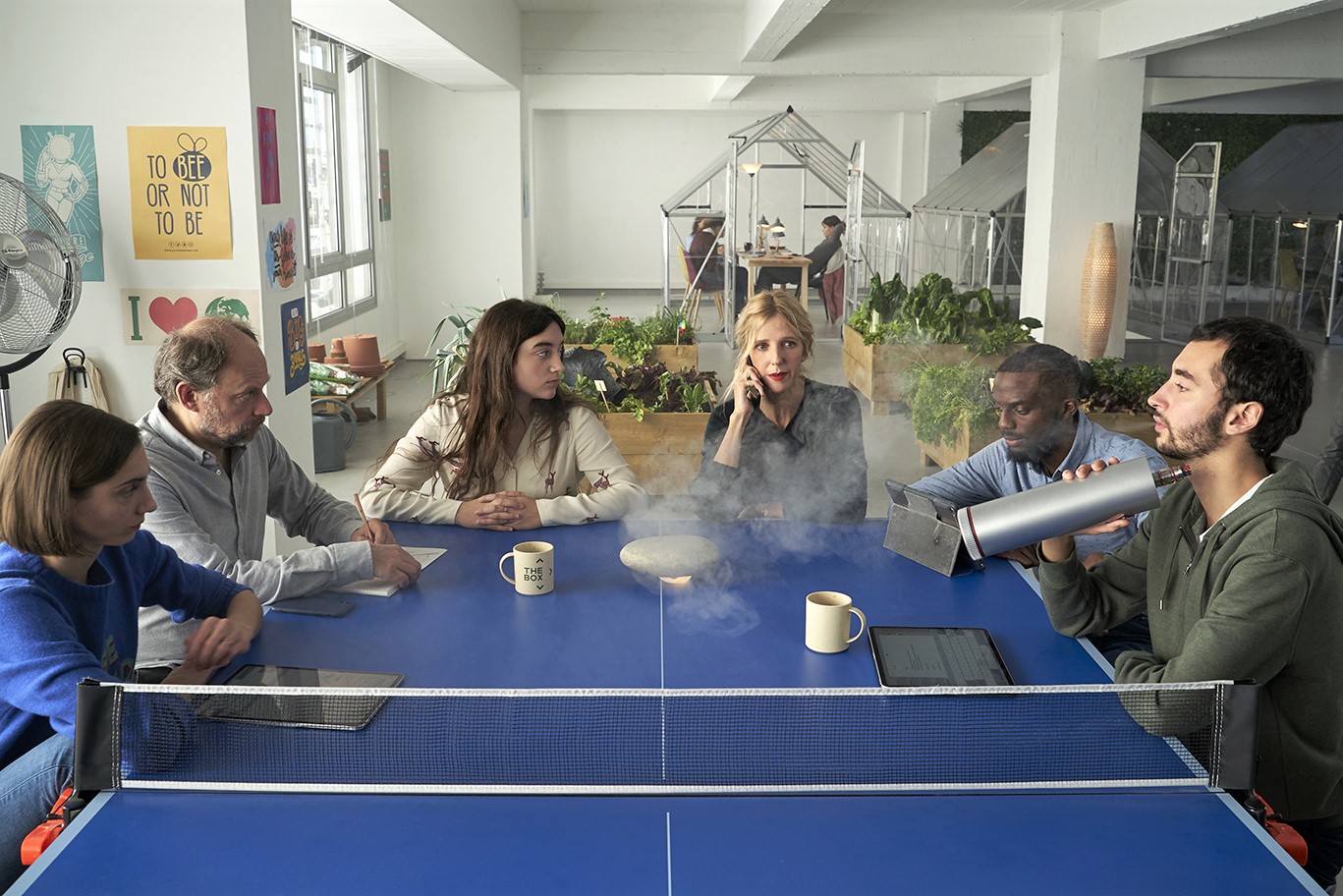 Employees of fictional company The Box have a meeting at the ping pong table in the film French Tech