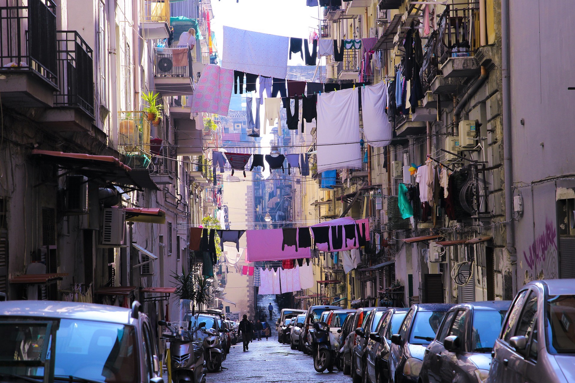 Laundry lines hanging above one of the narrow streets of Naples in Italy.